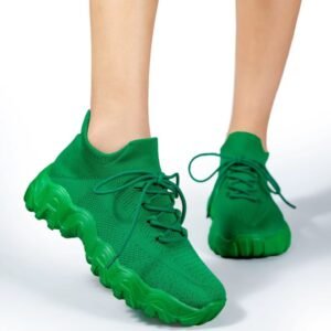 woman wearing green sneakers for women and lifting one foot up