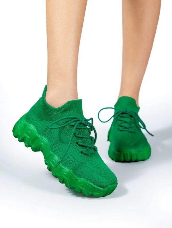 woman wearing green sneakers for women and lifting one foot up