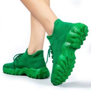 woman turned to her back wearing green sneakers for women