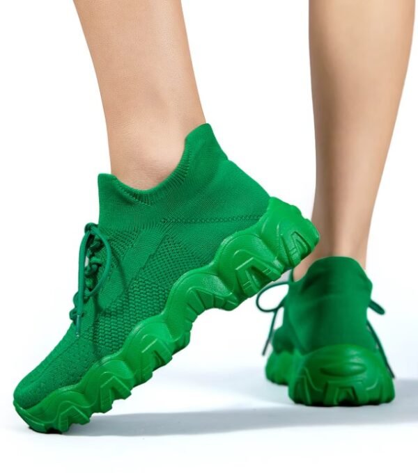 woman turned to her side wearing green sneakers for women