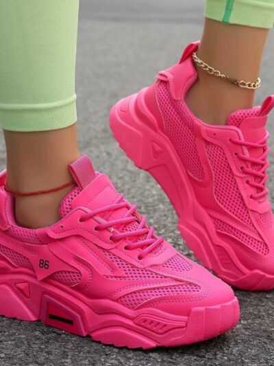 woman wearing hot pink sneakers and pastel green leggings