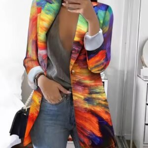 woman wearing multicolored blazer and jeans, she is holding her phone