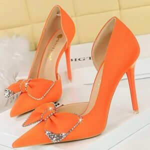 orange heels standing on a white box