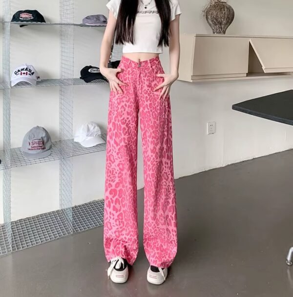 woman putting her hands into the pocket of pink leopard print pants