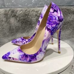 left side of purple floral heels on a white stool