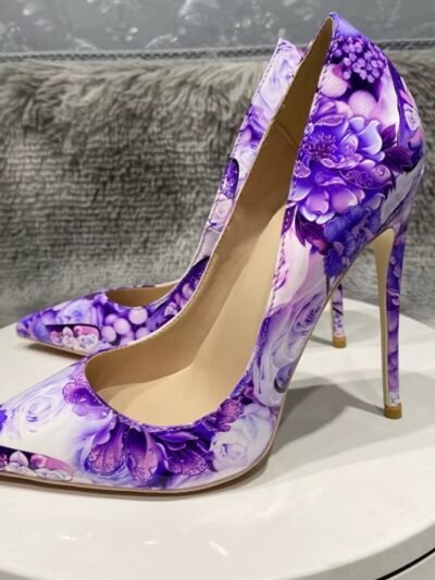 left side of purple floral heels on a white stool