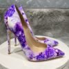 right side of purple floral heels on a white stool