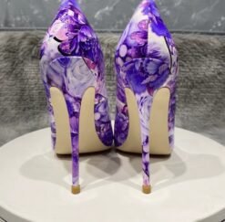 back view of purple floral heels on a white stool