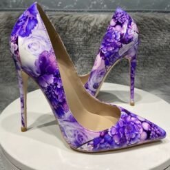 side view of purple floral heels on a white stool
