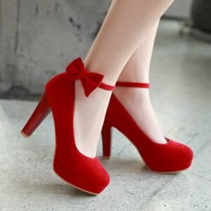 woman walking in red pumps on a concrete