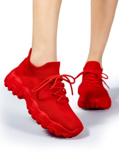 woman wearing red sneakers for women and lifting one foot up