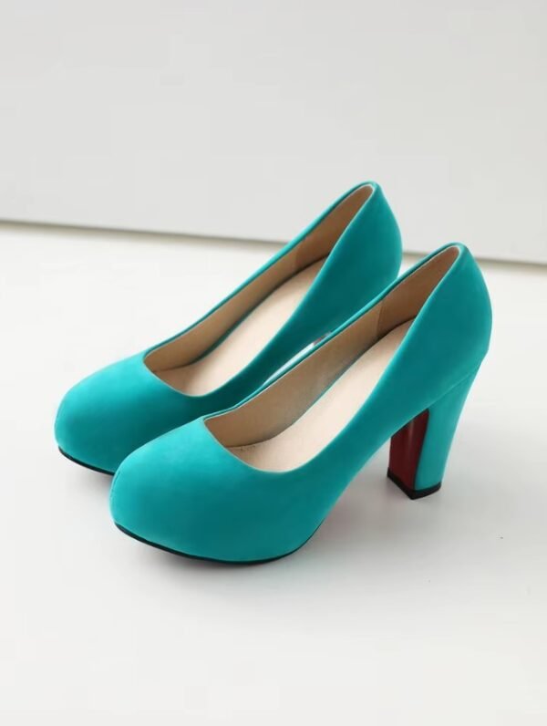 side view of turquoise heels on the white floor