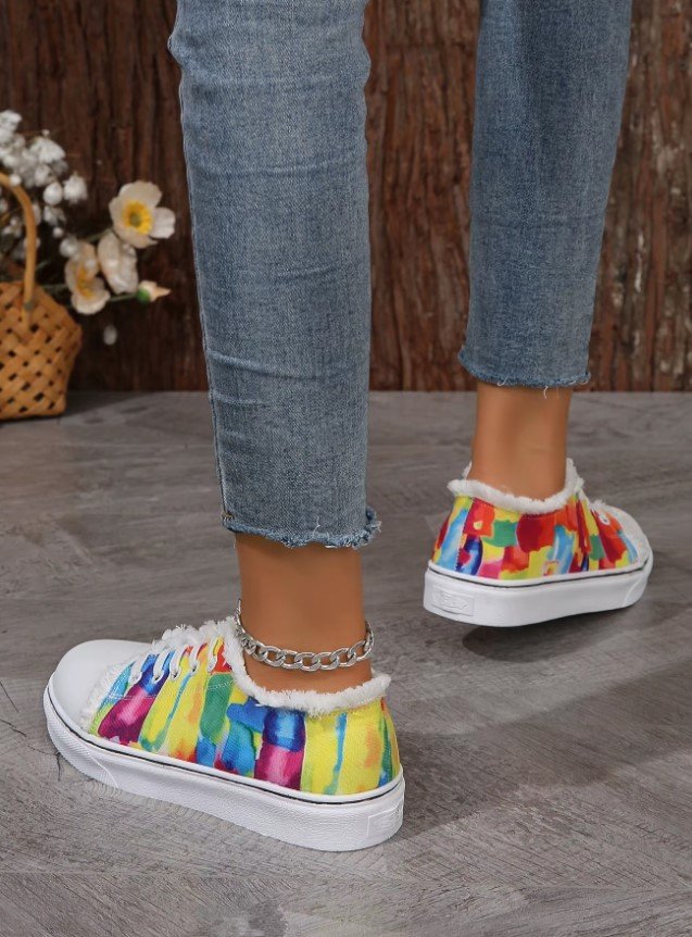 woman turned to her back wearing vintage colorful sneakers and grey jeans