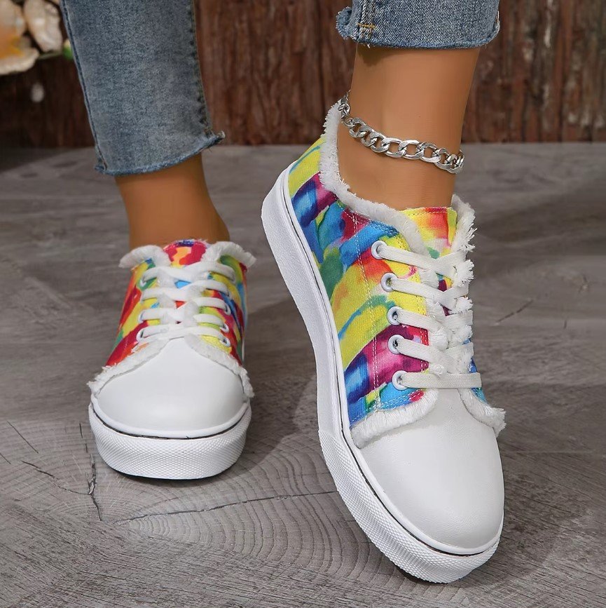 woman wearing vintage colorful sneakers, silver ankle bracelet and grey jeans