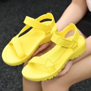 yellow sandals lying on woman's lap