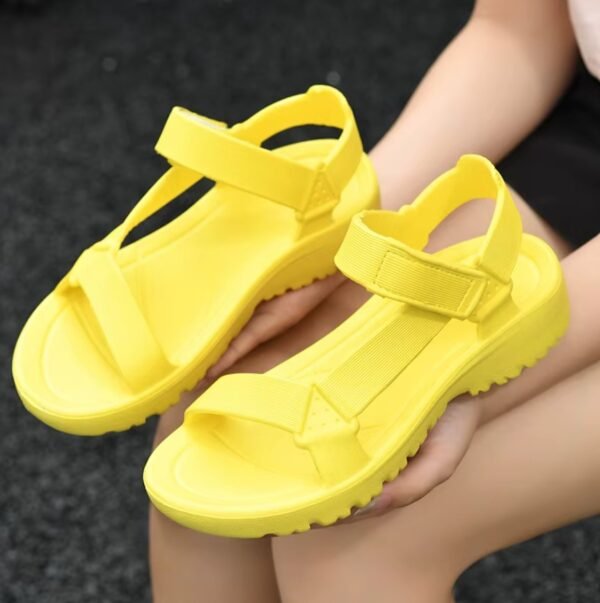 yellow sandals lying on woman's lap