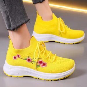 woman wearing yellow sneakers women on the grey background