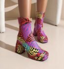 woman wearing colorful boots with heels on the beige floor