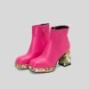 side view of pink colorful Chelsea boots on the grey background