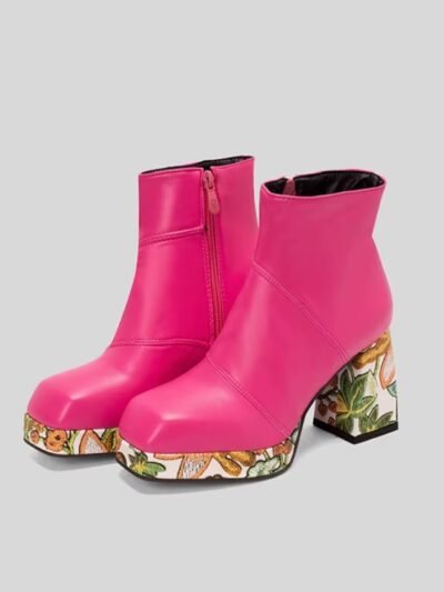 side view of pink colorful Chelsea boots on the grey background