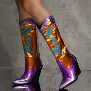 woman wearing colorful cowboy boots on the grey background