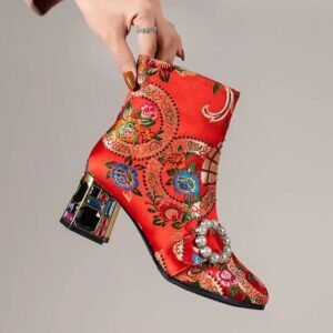 woman holding colorful embroidery boots