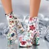 woman wearing colorful floral boots, shiny grey background