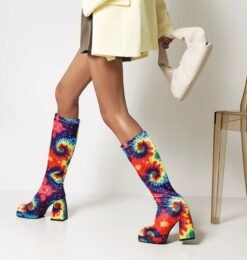 woman walking in colorful high heel boots and beige blazer