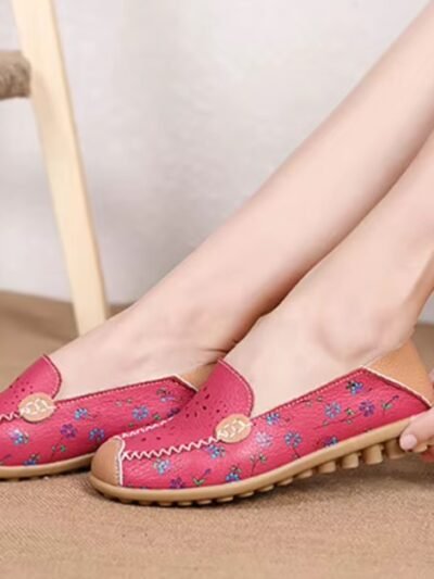 woman wearing colorful leather loafers and holding their edge