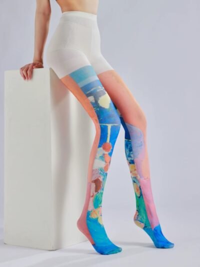 woman wearing colorful oil painting tights and sitting on a white elevation, grey background