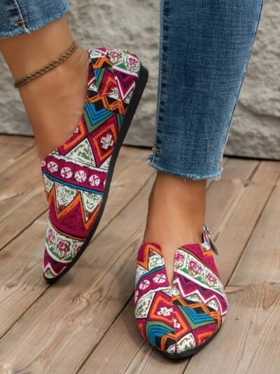 woman wearing pink colorful summer flats and jeans on the wooden floor