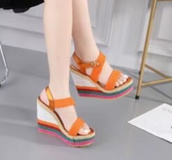 woman wearing colorful summer wedges and crossing her legs