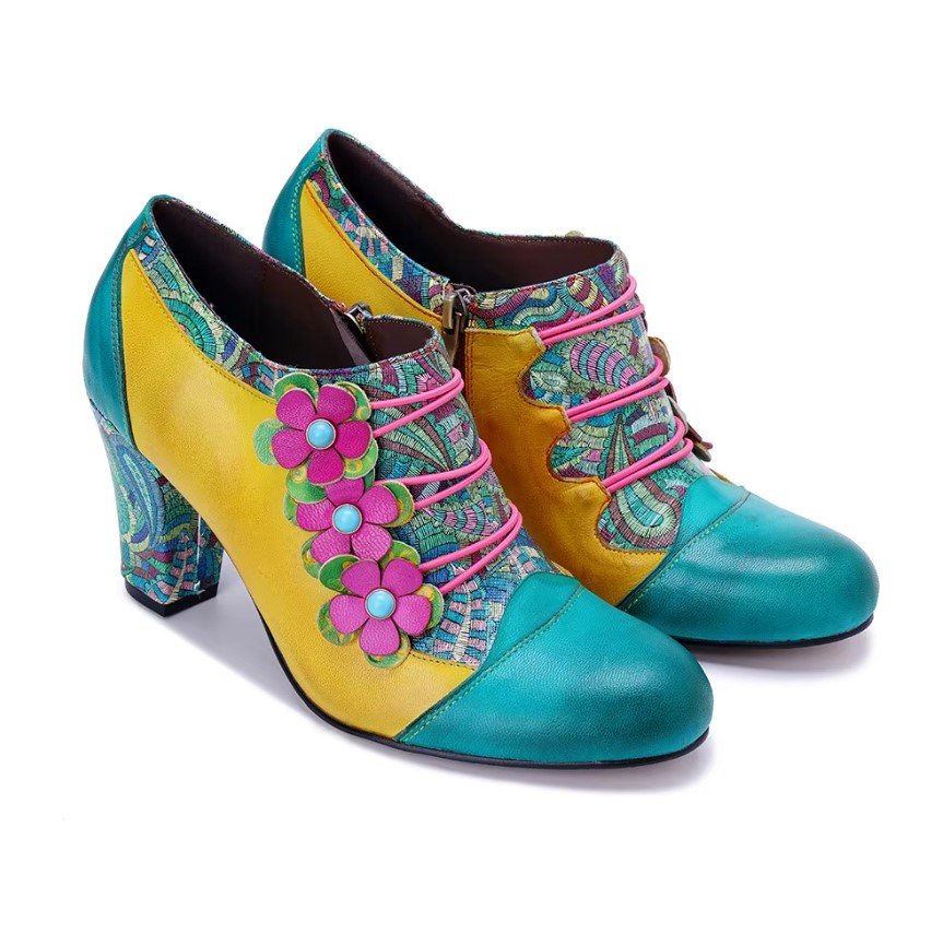 side view of colorful vintage boots on the white background