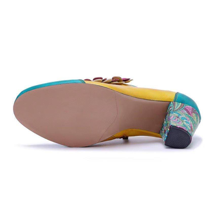 beige sole of colorful vintage boots on the white background