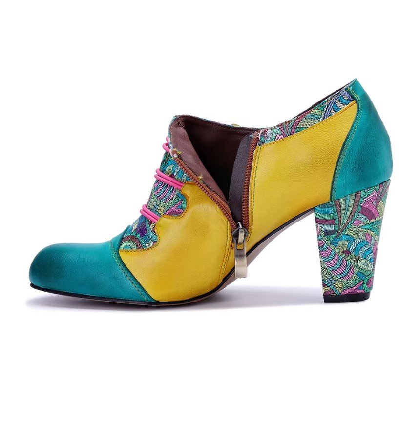 side view and a zipper of colorful vintage boots on the white background