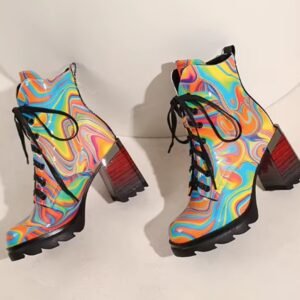 side view of colorful winter boots lying on a white table