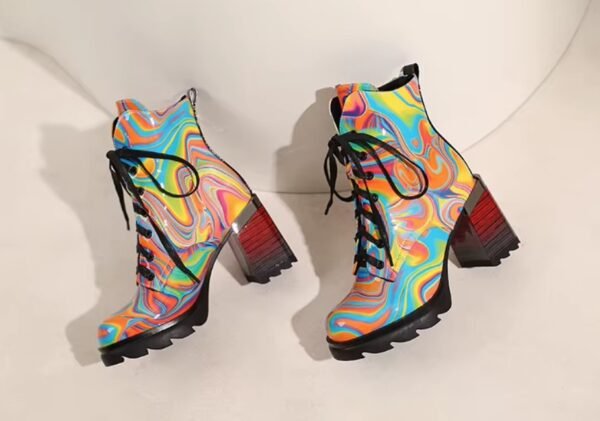 side view of colorful winter boots lying on a white table