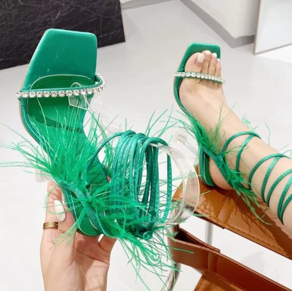 woman wearing one of green festive colorful sandals and wearing the other one