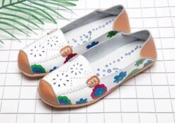 front view of floral colorful loafers on the white paper
