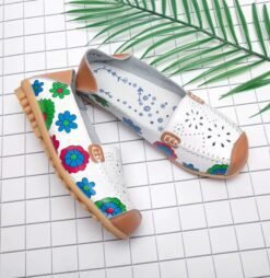 side view of floral colorful loafers on the white paper