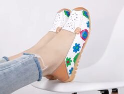 woman wearing floral colorful loafers and jeans