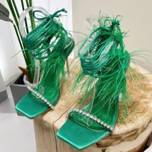 green festive colorful sandals lying on a wooden stool