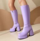 woman wearing lavender boots on the beige floor, light brown wall in the backgorund