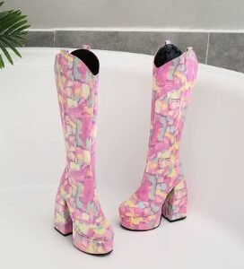 front view of long colorful boots lying on a white surface