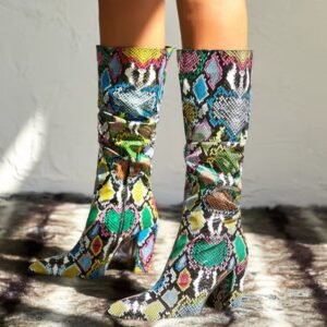 woman wearing mid-calf colorful boots on the grey floor