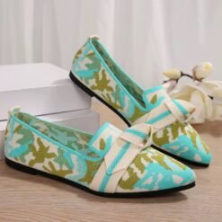 multi colored loafers lying on a wooden floor