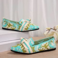 multi colored loafers lying on a white box