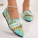 woman wearing multi colored loafers and white ankle bracelet