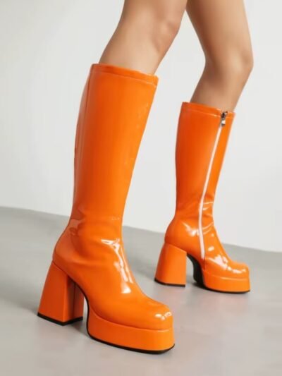 woman standing in orange boots on the grey floor