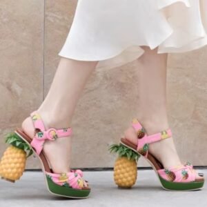 woman walking on the street wearing pineapple sandals and a white dress